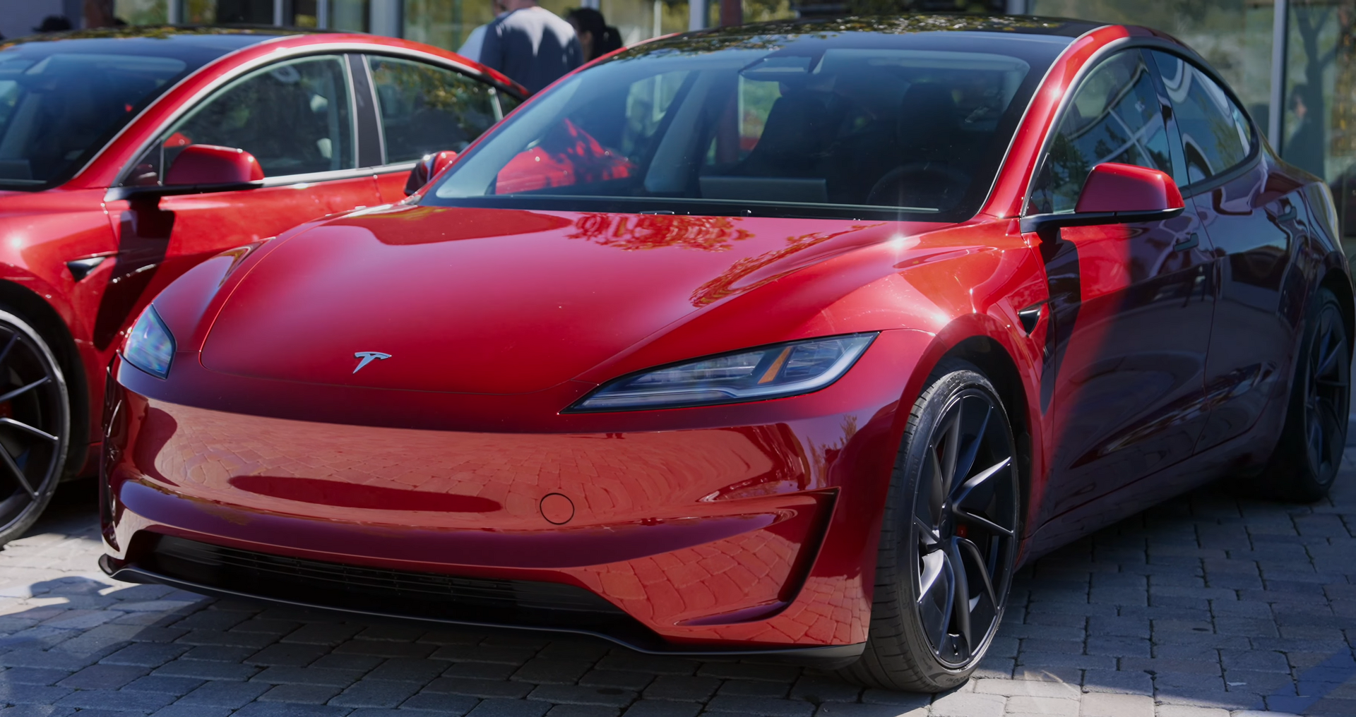 Red Tesla Model 3 Performance with distinctive front fascia, Warp wheels and red brake calipers
